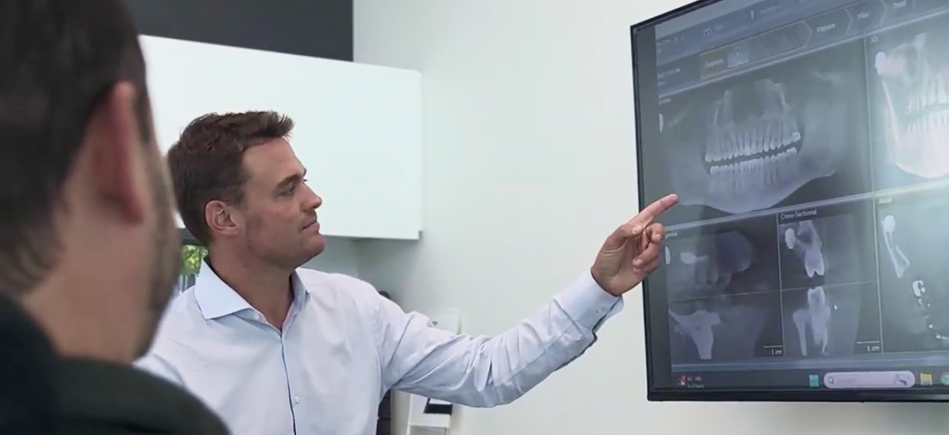 Dentist reviewing a CBCT scan with a patient at Plaza Pointe Dental Specialists