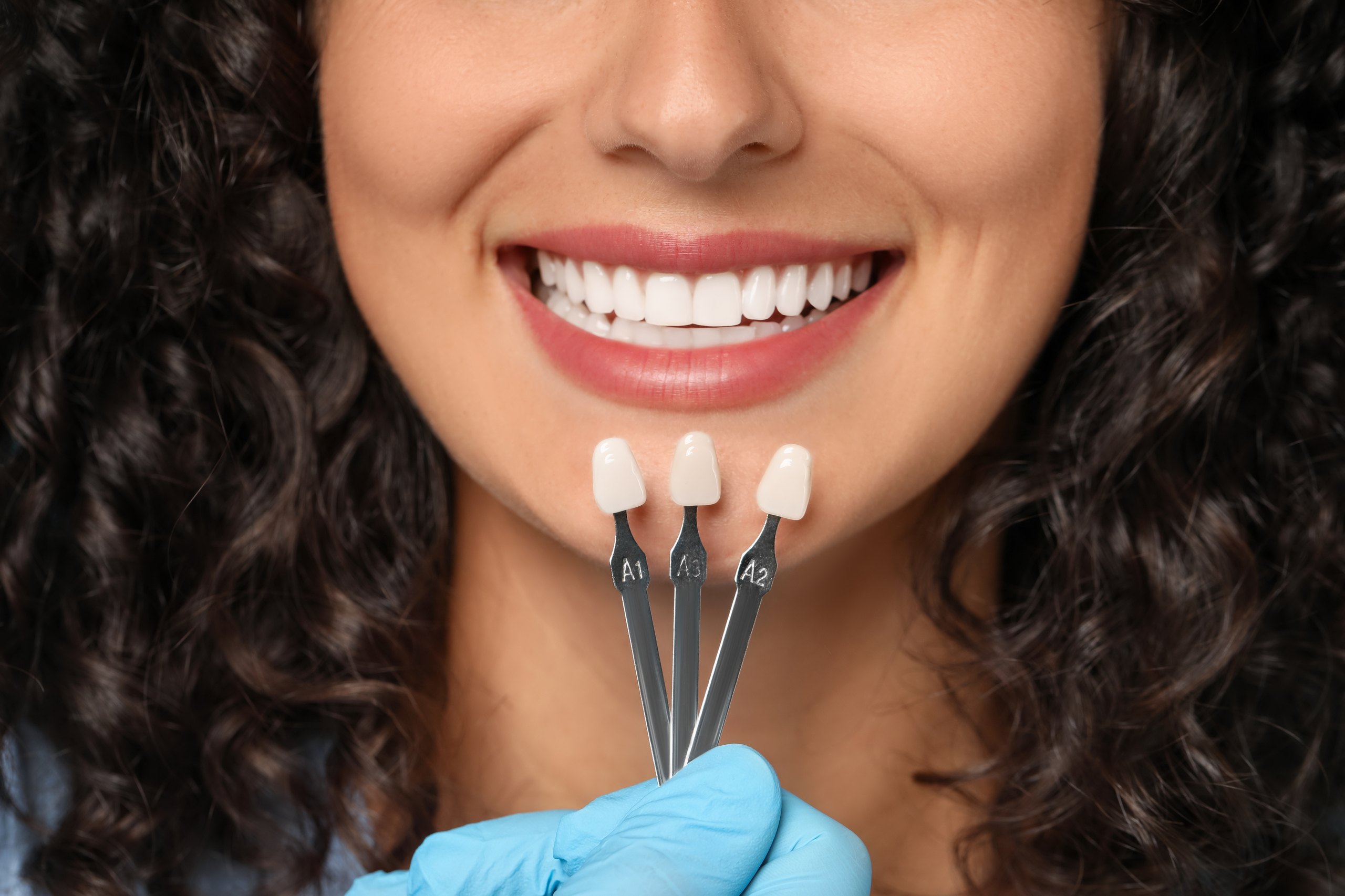 Patient reviewing porcelain veneer samples with prosthodontist at Plaza Pointe Dental Specialists, Mukilteo, WA